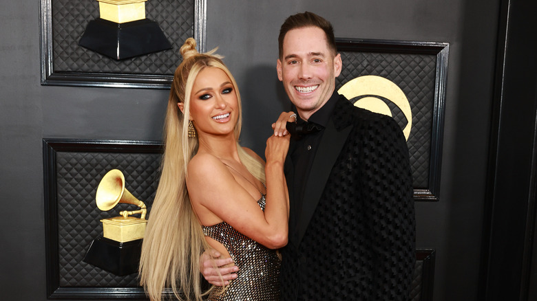 Paris Hilton and Carter Reum smiling on the red carpet