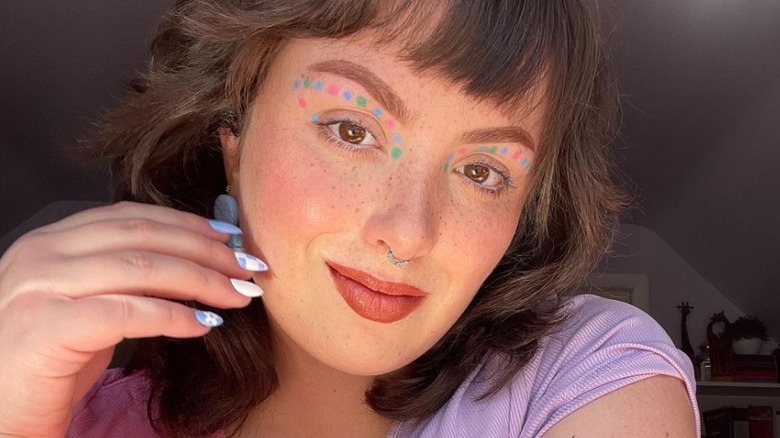 woman with pastel dots of makeup