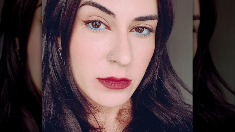 woman with blue eyeliner on lower lids