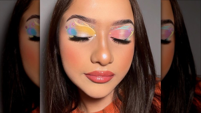 woman with intricate pastel makeup