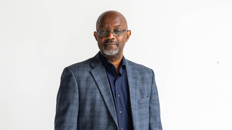 Pastor Cal Roberson posing in a gray suit