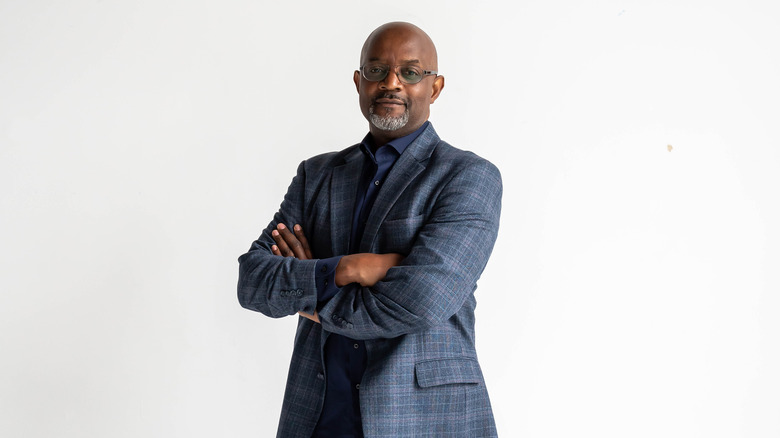 Pastor Cal Roberson standing with arms folded