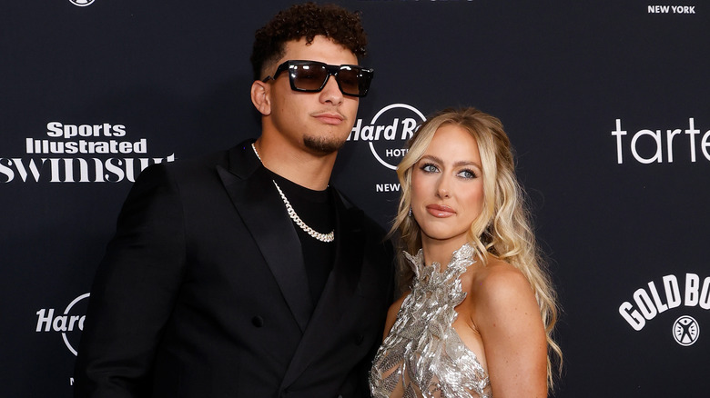 Brittany and Patrick Mahomes posing for photos