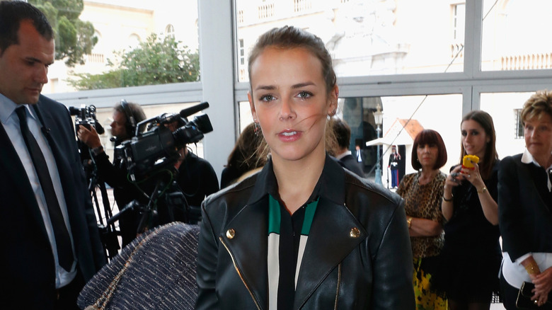 Pauline Ducruet attends a Louis Vuitton show and poses in a leather jacket.