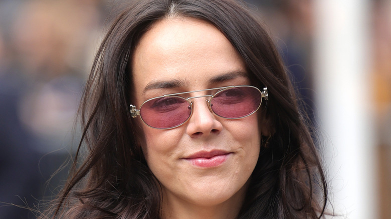 Pauline Ducruet smiles in a close up image wearing thin sunglasses.