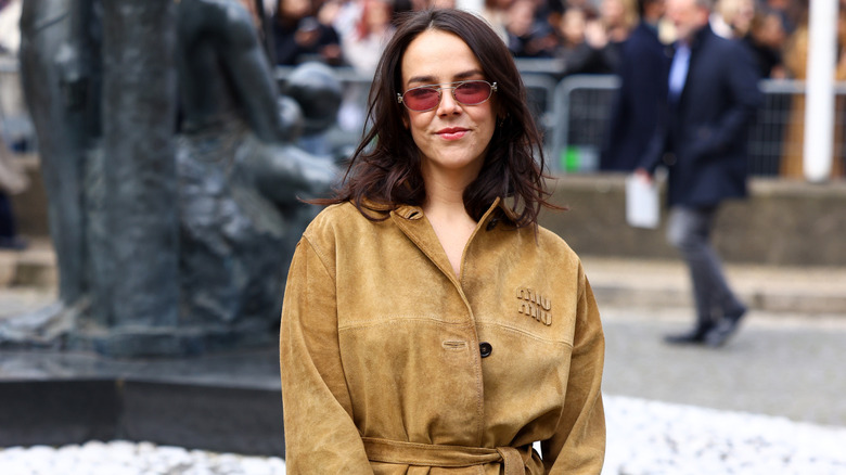 Pauline Ducruet wears a tan jacket while posing on a city street.