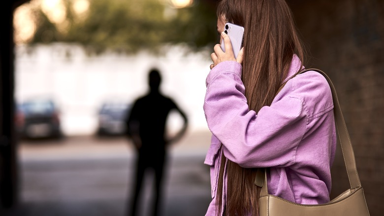 woman looking behind her at follower