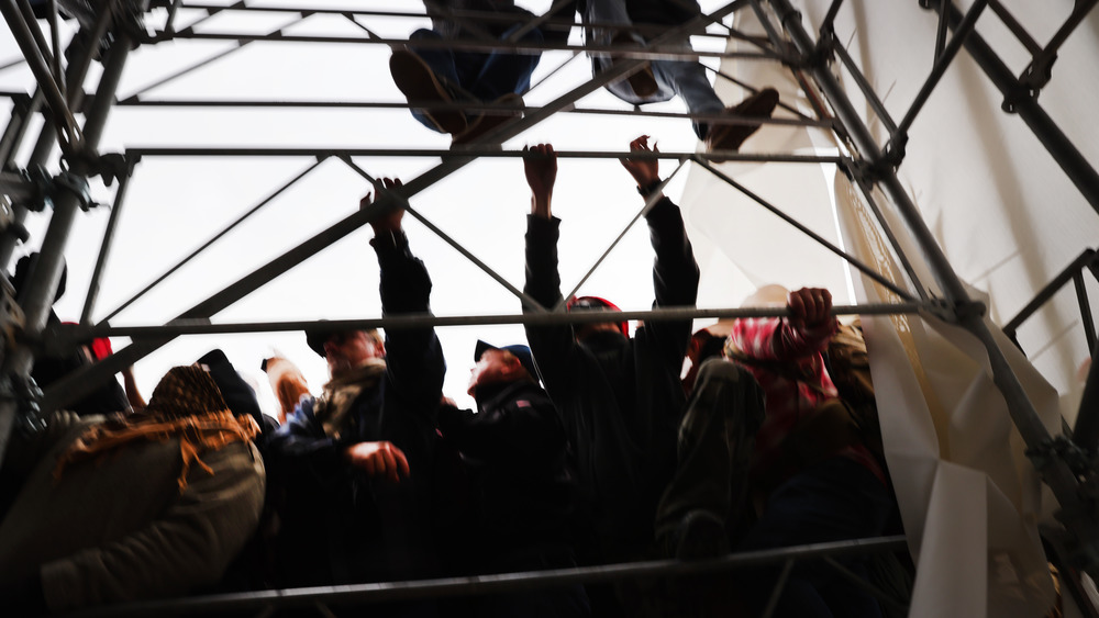 Rioters climbing scaffolding