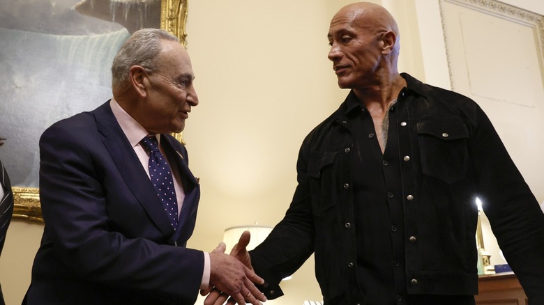 Chuck Schumer and Dwayne Johnson shaking hands