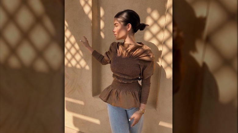 Woman wearing brown peplum top