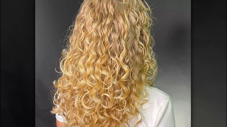 girl with long blonde permed hair