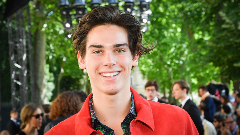 Paris Brosnan smiling on the street at BERLUTI fashion event in 2019