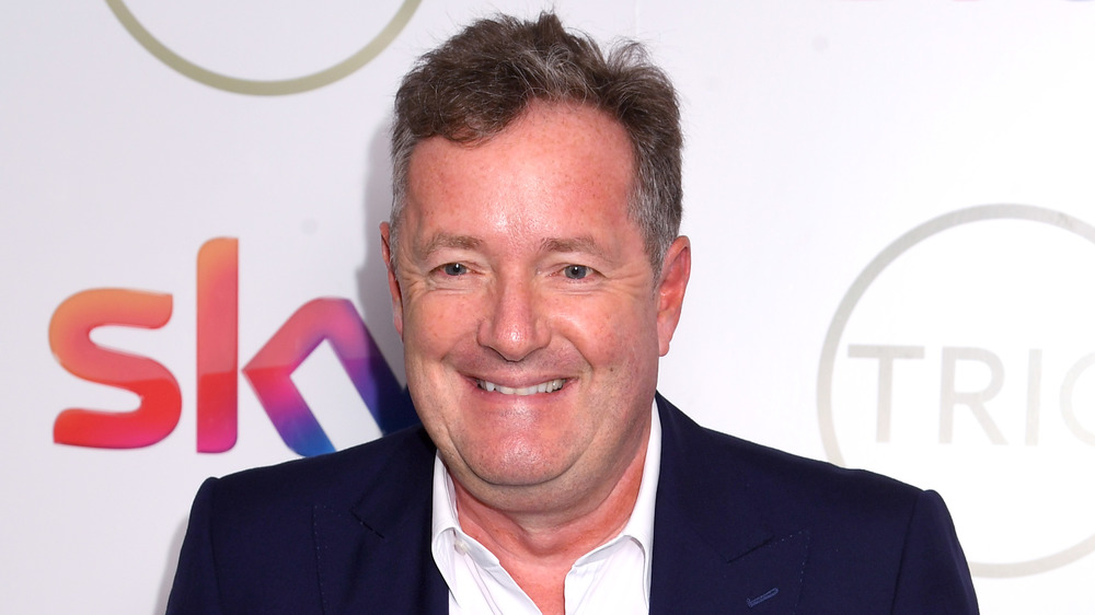 Piers Morgan grins at an event