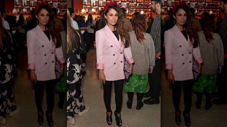 woman in pink blazer and red headband