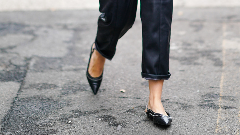 woman wearing pointed ballet flats