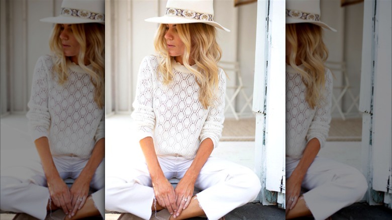 Blond in all-white outfit and hat