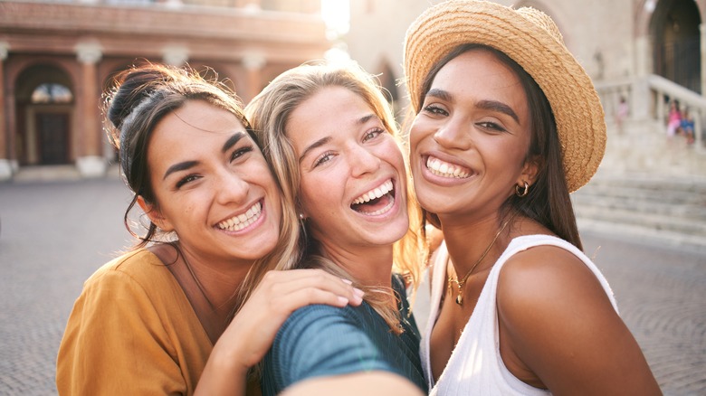 three girls smiling in selfie