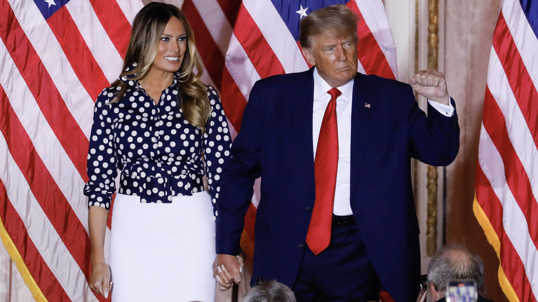 Melania Trump holding hands with Donald Trump