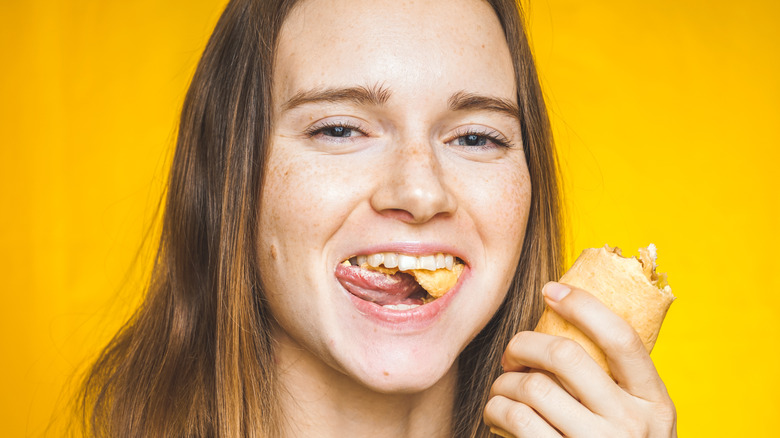 woman chewing with mouth open