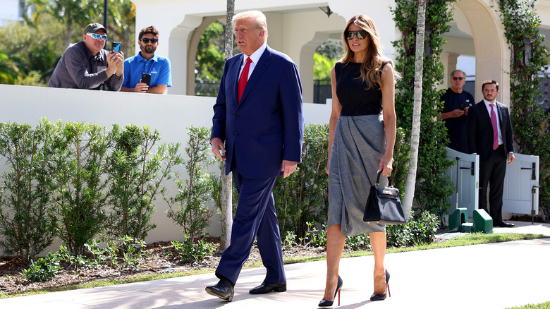 Donald, Melania Trump walking together