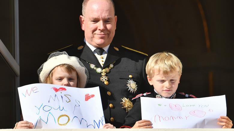 Jacques and Gabriella holding signs dedicated Charlene