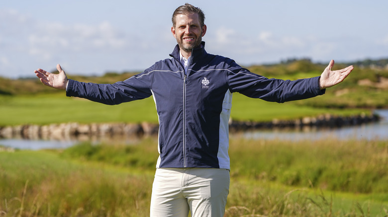 Eric Trump raising arms in triumphant pose