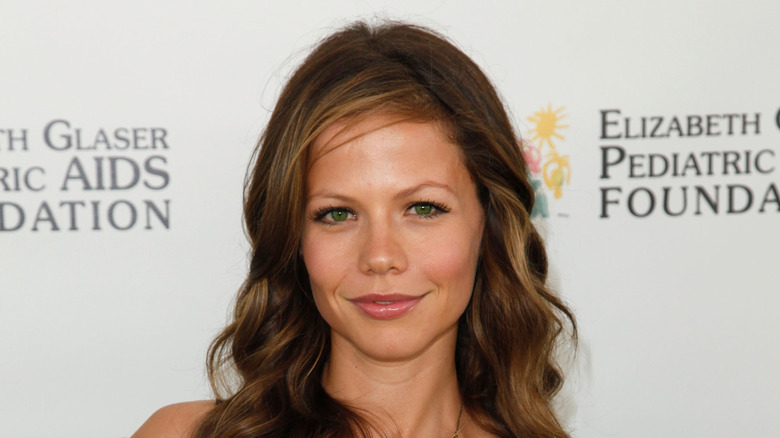 Tammin Sursok smiling at event