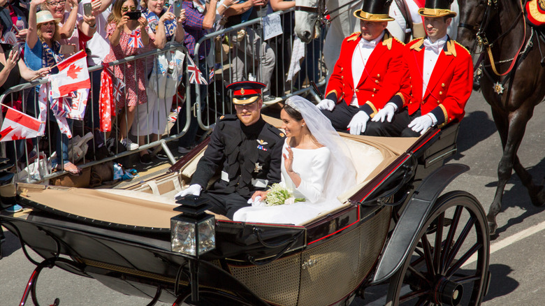 Prince Harry and Meghan Markle riding in a carriage 