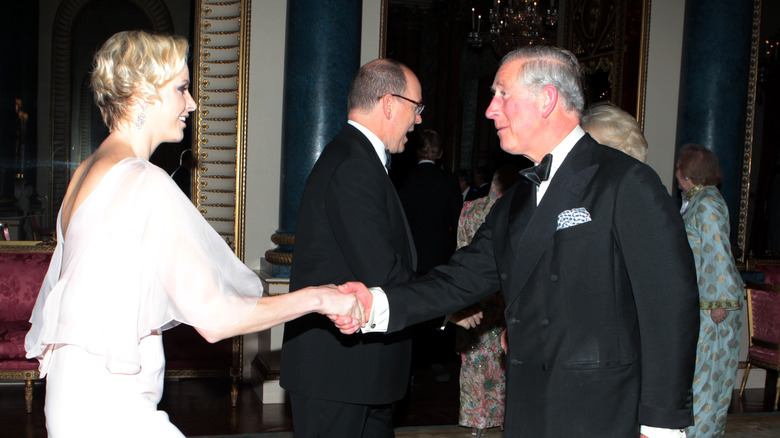 Prince Albert II and Princess Charlene greeting British royals