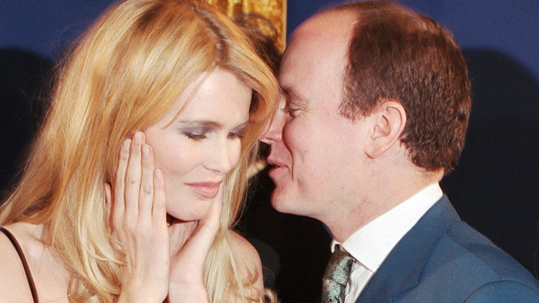 Albert whispering into Claudia Schiffer's ear