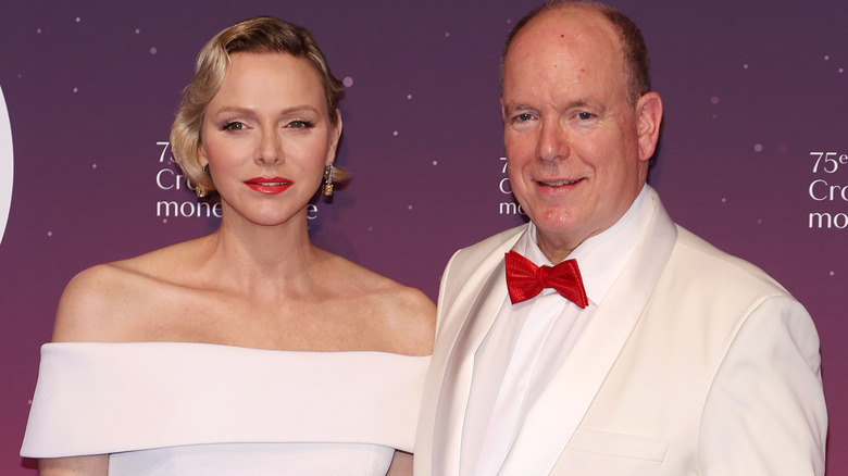 Princess Charlene and Prince Albert posing at event