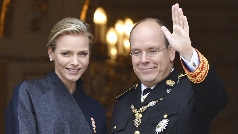 Princess Charlene and Prince Albert smiling & waving