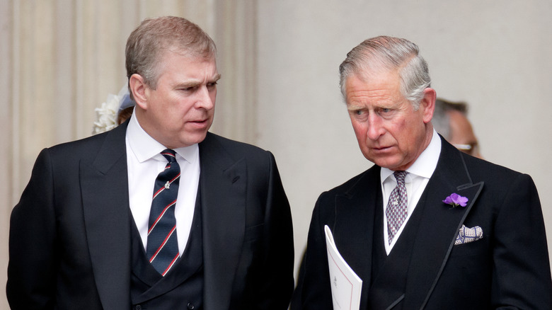 Prince Andrew looking at King Charles III