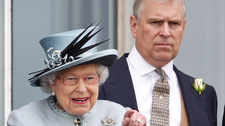 Prince Andrew standing next to Queen Elizabeth II