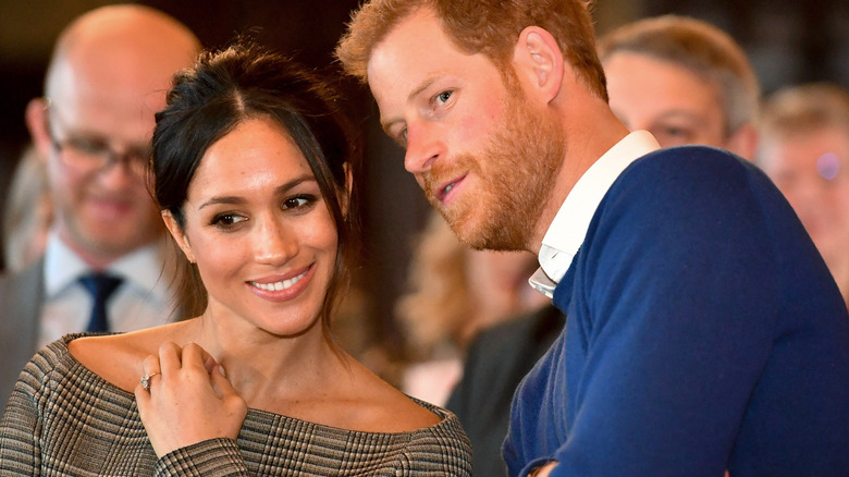 Meghan Markle and Prince Harry confer about something