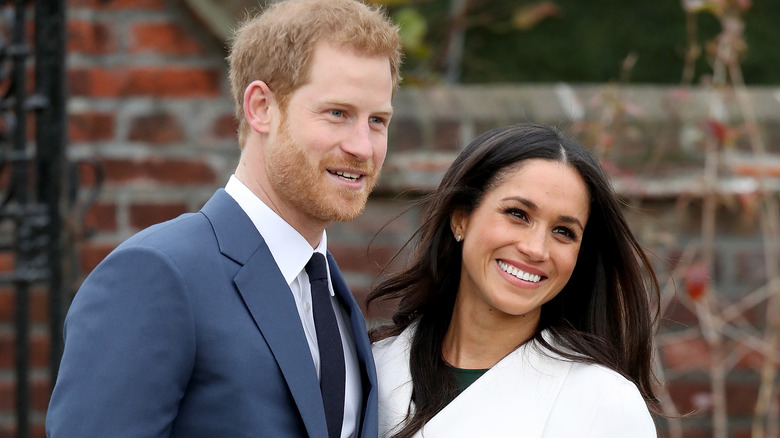 Prince Harry and Meghan Markle smiling