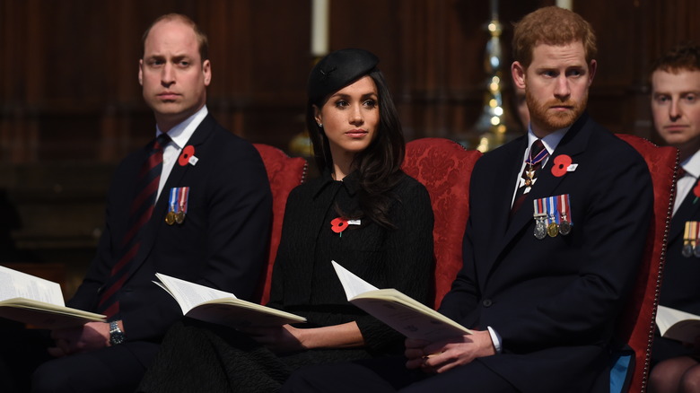 Prince William, Meghan Markle and Prince Harry looking somber at an event