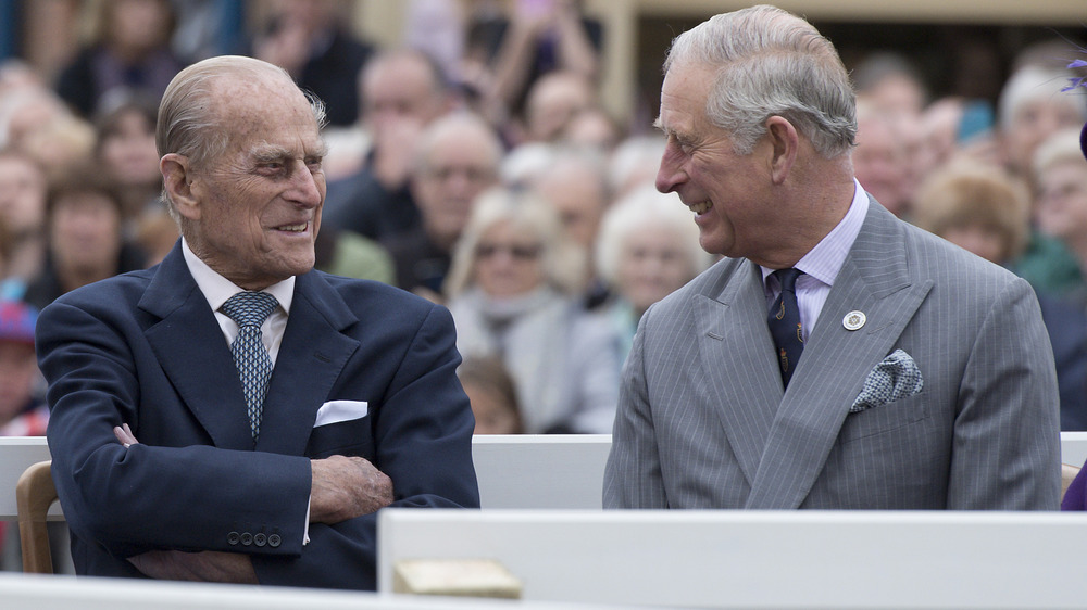 Prince Philip and Prince Charles talking