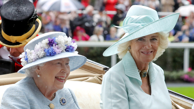 Queen Elizabeth and Camilla Parker Bowles smiling 