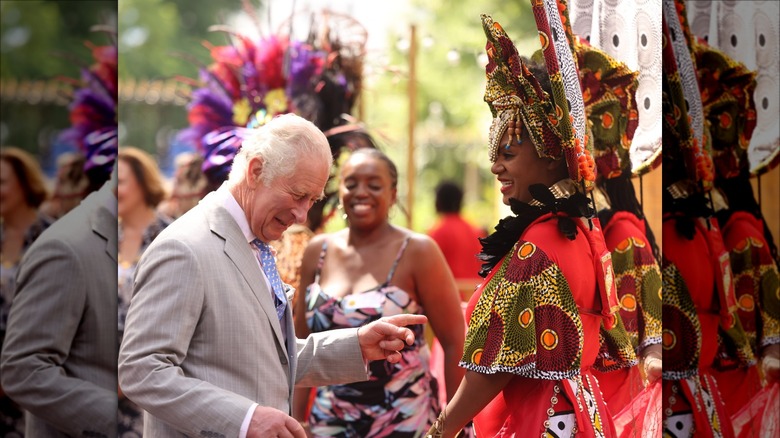 Prince Charles smiling while greeting people at the Notting Hill Carnival in London