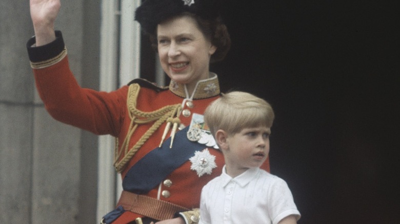 Queen Elizabeth with young Prince Andrew on a balcony