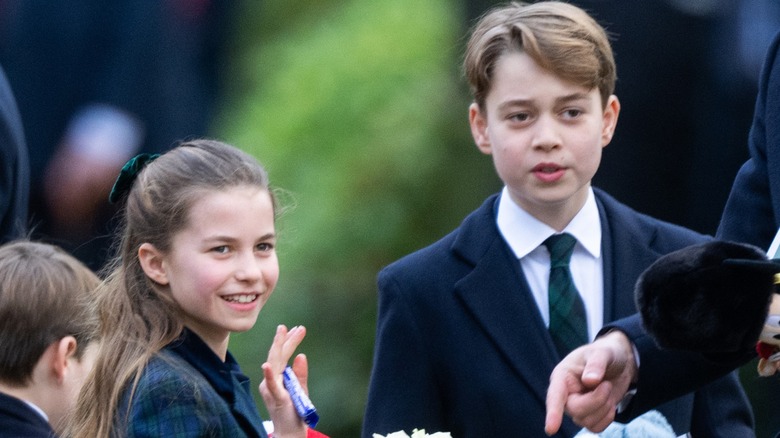 Princess Charlotte waving with Prince George