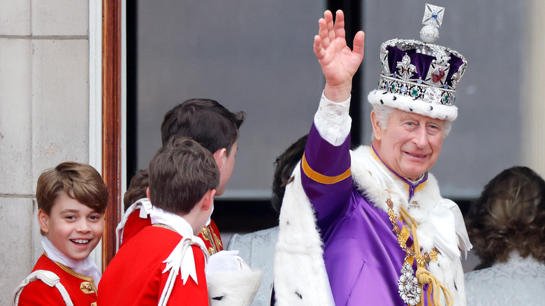 King Charles waving at coronation with Prince George