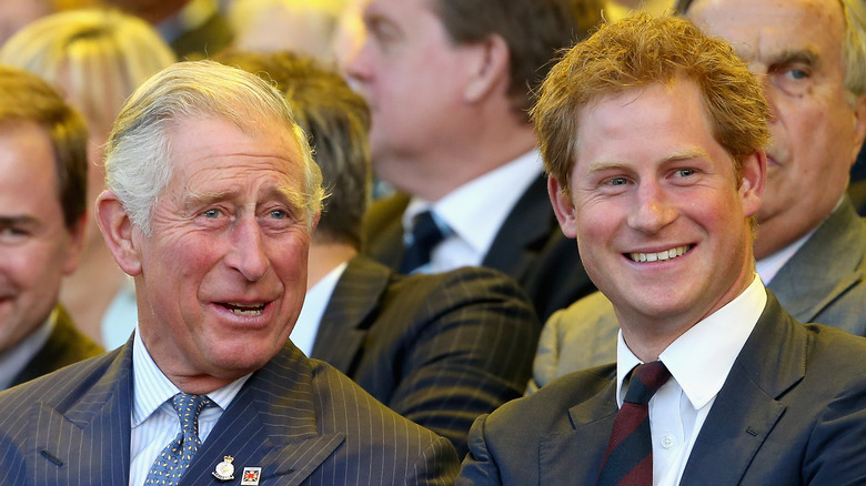 King Charles and Prince Harry talking and smiling 