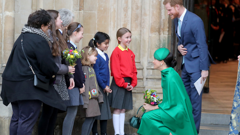 Prince Harry and Meghan Markle addressing fans