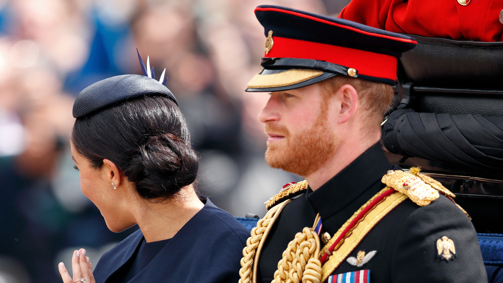 Prince Harry and Meghan Markle riding in a car