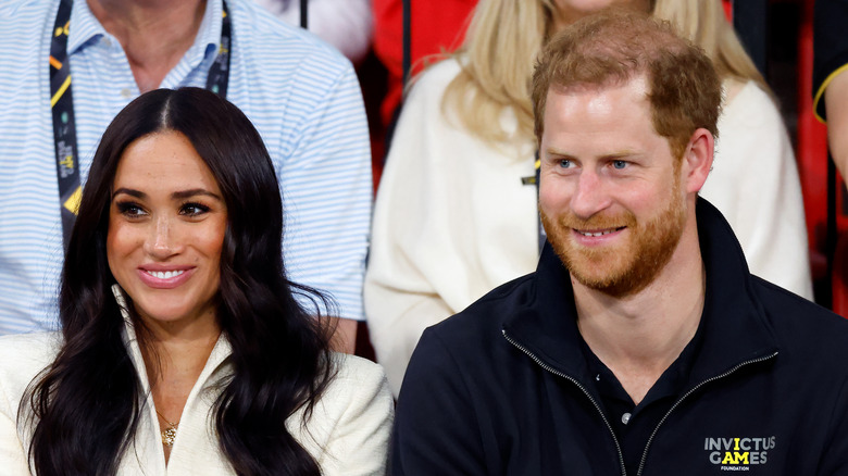 Meghan Markle and Prince Harry smiling at an event