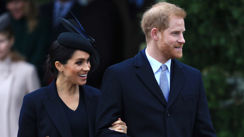 Meghan Markle and Prince Harry smiling, arm in arm