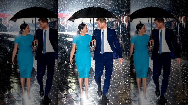 Prince Harry and Meghan Markle smiling in rain