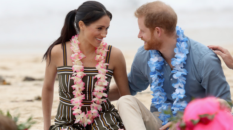 Prince Harry and Meghan Markle smiling on beach